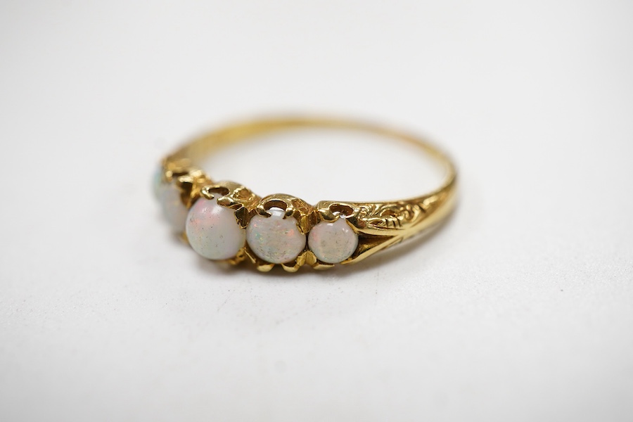 A late Victorian yellow metal and five stone graduated white opal set half hoop ring, the inner shank engraved 'Bran? Ap 4.89', size L.